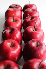 Two rows of red ripe apples tightly fitted to each other stretching into the distance. Red apples image for vertical story
