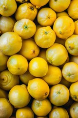 A vibrant pile of fresh yellow lemons, with one area blurred for privacy or focus effects