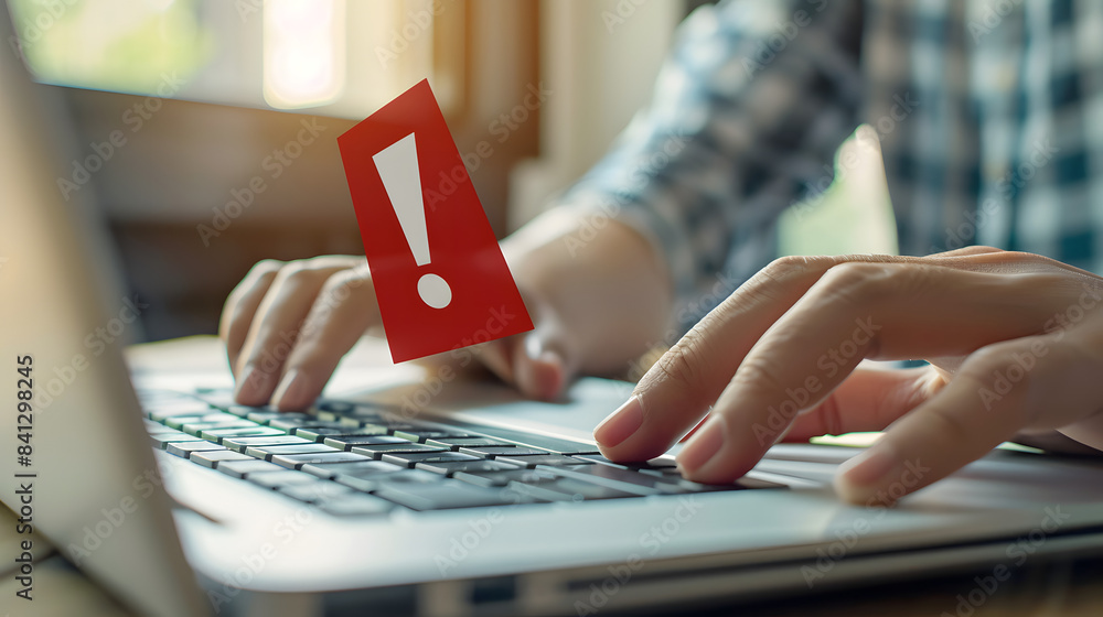 Aufkleber man typing on laptop with red exclamation mark sign. warning about cyber attack