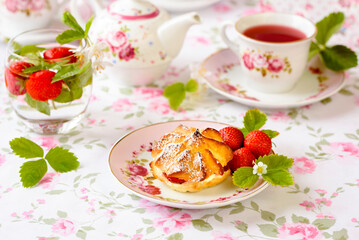 Cream puffs cakes or profiterole filled with whipped cream served with strawberries