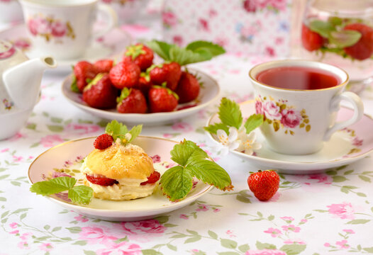 cup of tea with cream fuff and strawberries