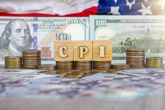 CPI, consumer price index symbol. wooden block with words CPI, consumer price index on dollar bills. Business and CPI, consumer price index concept.