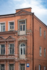 The facade of a red brick building against a blue sky