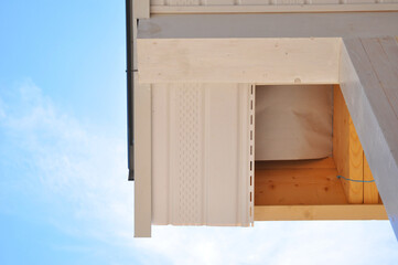 Close up on soffit board installation on the house roof corner. Fascia and soffit board installation