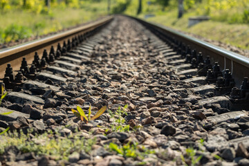 The railway track stretches into the distance. Close view of the railway.