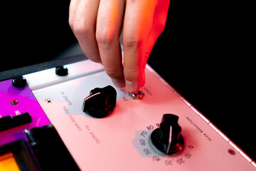 Obraz premium in the recording room under neon lighting professional remote control for adjusting the sound the director turns on the toggle switch on the amp
