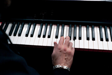 close up in the recording room dark studio sound engineer while playing, records the sound of synthesizer selecting the desired k