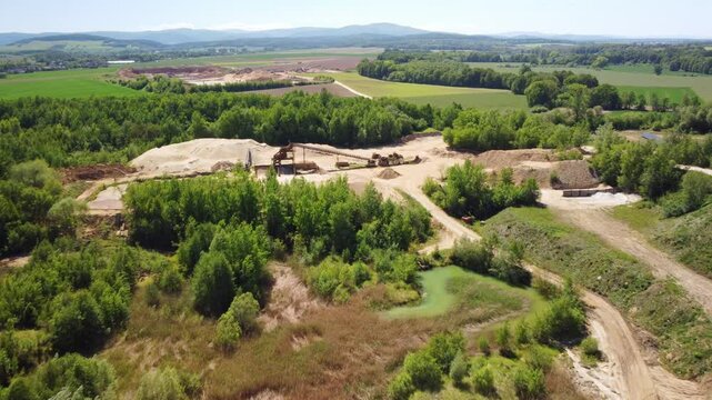 An Old Sand Mine Located in the Midst of a Lush Green Landscape Near the town of Prudnik, Poland - Drone Flying Forward