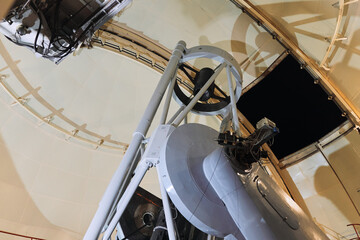 Giant telescope under clock tower in observatory building, time to stargaze and explore the universe
