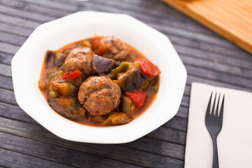 Cooked meatballs with stewed eggplant in bowl