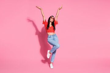 Full size photo of pretty young woman raise hands dancing wear top isolated on pink color background