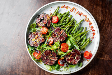 beef steak tataki served with vegetables salad and green bean
