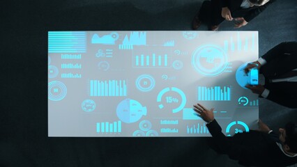 Diverse business people group discussing and brainstorming about marketing strategy with hologram of data analysis statistic or marketing investment graph while sitting at meeting room. Directorate.