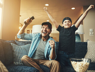 Television, child and man with success on sofa for streaming, subscription or watching sports together. Kid, dad and popcorn with tv remote at home for bonding, celebration or live broadcast of match
