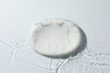 Presentation for product. Marble podium in water on white background, top view