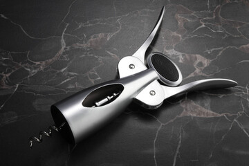 One wing corkscrew on black marble table
