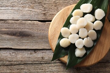Fresh raw scallops on wooden table, top view. Space for text