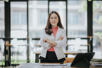 Attractive Asian businesswoman working at modern office with balance sheet documents. Accounting