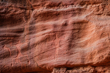 close up of 2000 years old Anfashieh inscriptions of Khazali canyon from the ancient bedouin nomads, etched into the rock surfaces of Jordan's majestic Wadi Rum desert