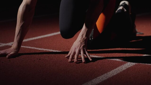 Start Of Runner Race, Closeup View Of Sportsman Hands On Floor And Legs In Starting Blocks, Details