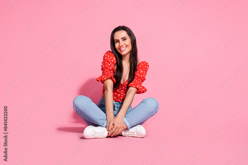 Poster Full size photo of pretty young woman sit floor empty space wear top isolated on pink color background