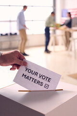 Hand Dropping Ballot Into Voting Box