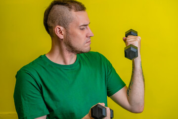 Man Lifting Green Dumbbells During Home Workout