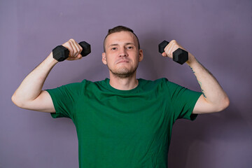 Man Lifting Green Dumbbells During Home Workout