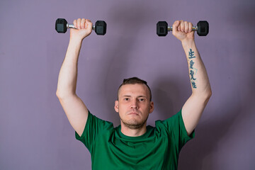 Man Lifting Green Dumbbells During Home Workout