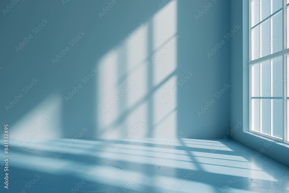 Poster there is an empty wall in light blue and a smooth floor with an interesting light glare. this backgr