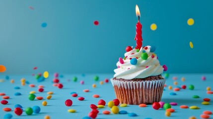 Celebration cupcake with a single red candle against a vibrant blue backdrop. Brightly colored sprinkles and candies enhance the joyful vibe. . AI