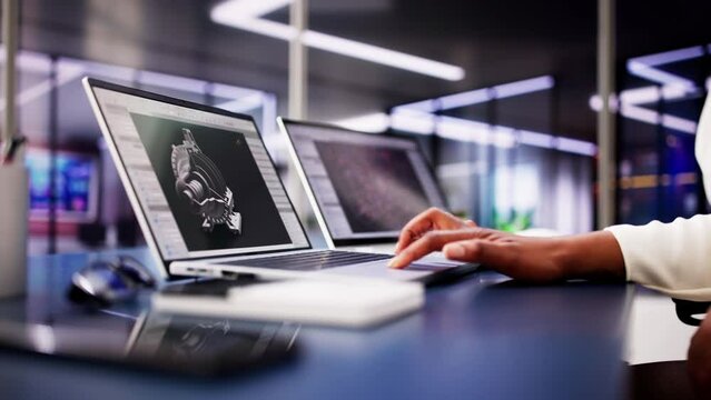 African American Female Engineer Developing Mechanical Parts Using 3D CAD Software on Laptop