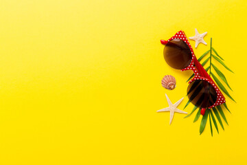 sunglasses with seashell lying on table background. Sunglasses on summer background. Top view flat lay with copy space for text