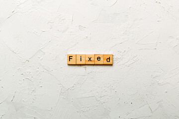 fixed word written on wood block. fixed text on table, concept