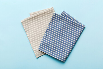 top view with blue kitchen napkin isolated on table background. Folded cloth for mockup with copy space, Flat lay. Minimal style