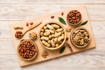 Walnut kernel halves, in a wooden bowl. Close-up, from above on colored background. Healthy eating Walnut concept. Super foods with copy space