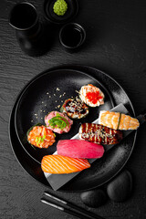 Nigiri composition on black background. The Art of Japanese Cuisine. Food photography for menu and sushi bar decoration