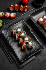 Sushi set composition on black background. The Art of Japanese Cuisine. Food photography for menu and sushi bar decoration