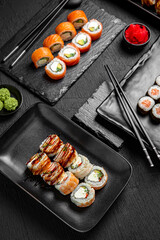 Sushi set composition on black background. The Art of Japanese Cuisine. Food photography for menu and sushi bar decoration