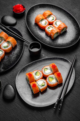 Sushi set composition on black background. The Art of Japanese Cuisine. Food photography for menu and sushi bar decoration