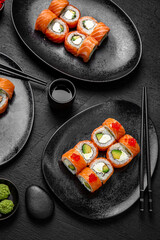 Sushi set composition on black background. The Art of Japanese Cuisine. Food photography for menu and sushi bar decoration