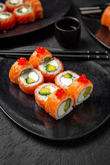 Sushi set composition on black background. The Art of Japanese Cuisine. Food photography for menu and sushi bar decoration