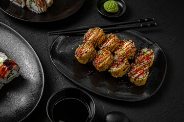 Sushi set composition on black background. The Art of Japanese Cuisine. Food photography for menu and sushi bar decoration