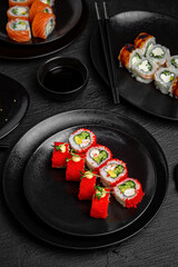 Sushi set composition on black background. The Art of Japanese Cuisine. Food photography for menu and sushi bar decoration