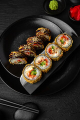 Sushi set composition on black background. The Art of Japanese Cuisine. Food photography for menu and sushi bar decoration