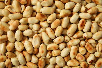 Many roasted peanuts as background, top view