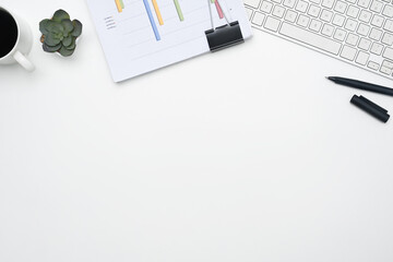 Office desk with financial reports, keyboard and cup of coffee. Top view with copy space