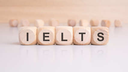 wooden cubes with letters form the expression IELTS. education concept