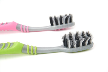 Old toothbrush that has been used and is worn out isolated on white background. Oral and teeth...