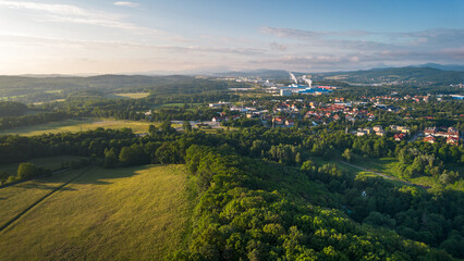 Aerial View of a Town Surrounded by Forest at Sunset